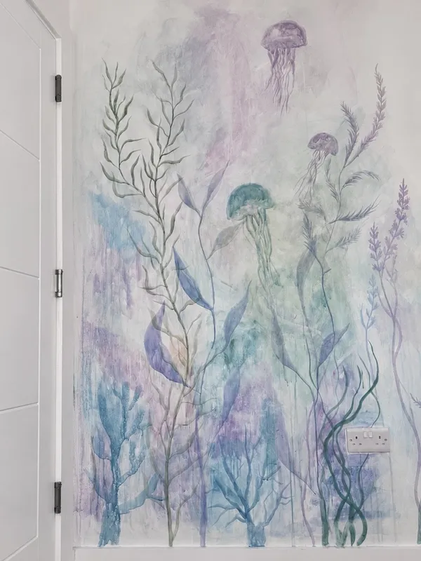 Underwater mural painted by Vera Hylands — translucent jellyfish drifting through painted kelp in soft purple and teal