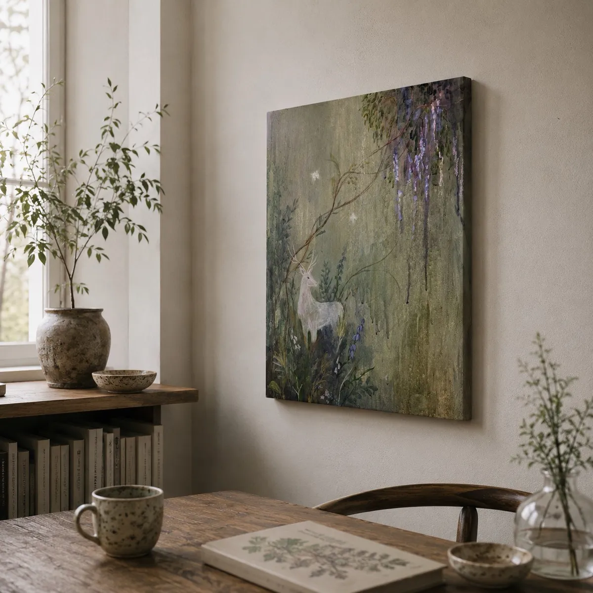 White Stag hung in a quiet study with a vase of greenery on the windowsill and a wooden table below